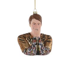 a ceramic ornament with a man's face and hands on his chest