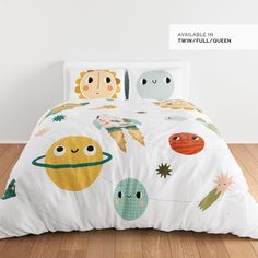 an image of a child's bed with space themed comforter and pillow cases