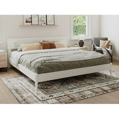 a white bed sitting on top of a wooden floor