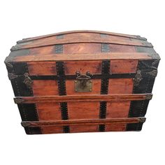 an old wooden chest with metal straps and latches on the top, isolated against a white background