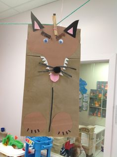 a cat made out of brown paper bag sitting on top of a table in an office