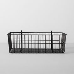 a black wire basket sitting on top of a table