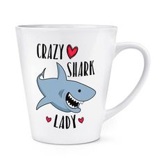 a white mug with a shark on it and the words crazy shark lady written in black