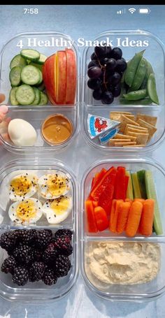 four plastic containers filled with different types of food