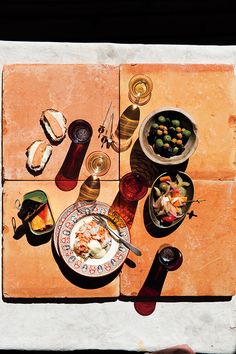 an overhead view of food and wine on a table