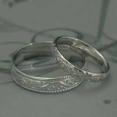 two wedding rings sitting on top of each other