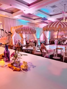 a table with flowers and candles on it in a room that is decorated for a wedding