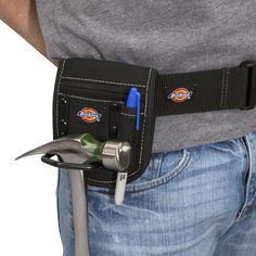 a man holding a tool belt with tools in it