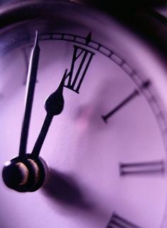 an analog clock with roman numerals is shown in this close up photo,