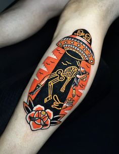 a person with a tattoo on their arm wearing an orange and black mexican style hat