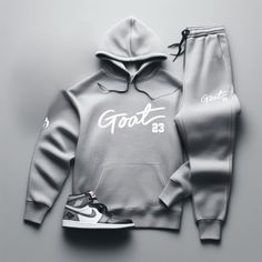 Yo, you looking for the freshest, most comfortable gear that perfectly matches your kicks? Check out our "GOAT 23" Grey Sneaker Sweatsuit To Match Air Jordan Retro 1! So don't wait. Cop now and step up your game with our FIRE! "GOAT 23" Men's Sneaker Sweatsuit To Match Air Jordan Retro 1. With fast shipping, hassle-free returns, and on-point customer service, Threads On Fire is the only choice for real sneakerheads who demand the FIRE! Check out our SneakerThreads Blog for all things sneakerhead culture, created by sneakerheads for sneakerheads! PREMIUM HOODIE MATERIAL Cotton 80% and Polyester 20% FEATURES Unisex, ribbed gusset wrist, ribbed bottom cuff, flat draw cord, 5-thread stitching, center hand warmer pocket. PREMIUM JOGGERS MATERIAL 8.5 oz., 3-end fleece, soft-washed, 100% cotton-f Jordan 1 Outfit Men, Grey Sweatsuit, Air Jordan Retro 1, Grey Tracksuit, Jordan 1 Outfit, Computer Basic, Jordan Retro 1, Joggers Set, Jordan 7