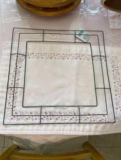 a white table cloth with a square design on it