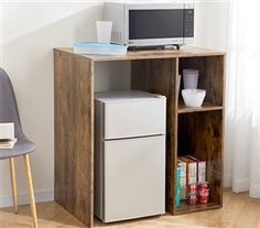 a microwave oven sitting on top of a wooden shelf