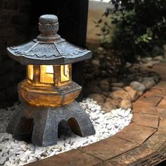 a stone lantern sitting on top of a pile of rocks