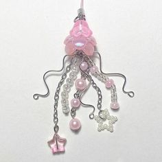 a pink and silver necklace with charms attached to it