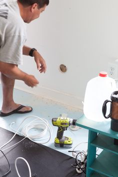 a man is working on a table with tools