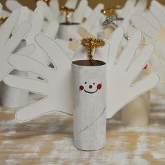 there is a white vase with a tree in it and other decorations on the table