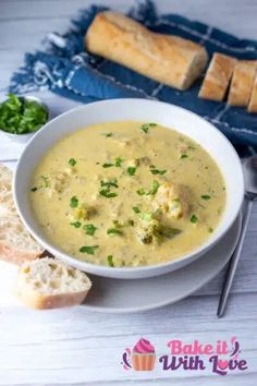 a bowl of soup with bread on the side