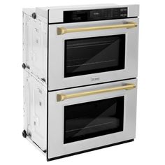 two white ovens side by side with gold trim on the front and bottom, against a white background