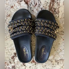 Excellent Condition Chanel Chain Slides. These Come In A Dark Navy Color With Beautiful Gold Chain Details And Cc Logos. These Are A European Size 39, However They Run About One Size Smaller And They Fit A True Us Size 8. Extremely Comfortable And Chic. Perfect For A Vacation Or Elevating Any Casual Outfit. I Have Worn Them To A Couple Of Events, Other Wise They Are Kept In Chanel Dust Bags With Tissues. Really No Signs Of Wear, Please See All The Photos. I Can Send More If Needed. Made In Italy Silk Lined Gold Details European 39 - Fits A True Us 8 Chanel Slides Will Come With Two Original Chanel Dust Bags. I No Longer Have The Box. Chanel Slides, Chanel Chain, Slides Sandals, Chanel Shoes, Navy Color, Gold Details, Dark Navy, Casual Outfit, Blue Gold