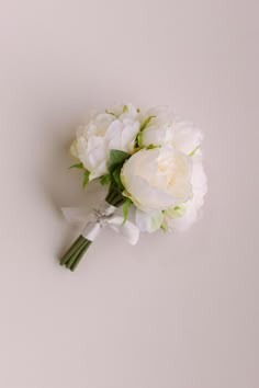 a bouquet of white flowers sitting on top of a table