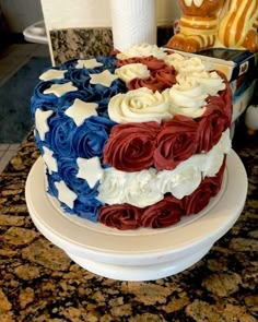 a cake with red, white and blue icing on it sitting on a table