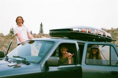 two women sitting in the passenger seat of a truck