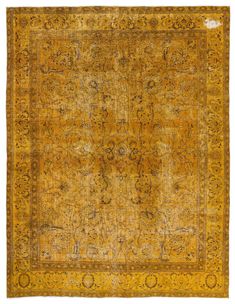 an antique rug with yellow and brown colors