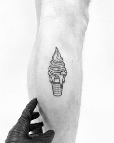 a man's leg with a tattoo on it that has a cupcake in the middle