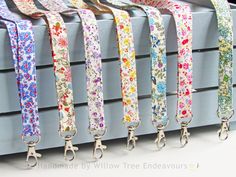 the leashes are lined up in rows on the wall, with flowers all over them