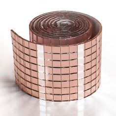 a roll of brown and white tile sitting on top of a table next to each other