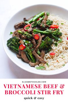 a white plate topped with beef and broccoli covered in sauce next to rice