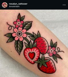 a tattoo design with strawberries and flowers on the leg