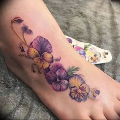 a woman's foot with flowers on it