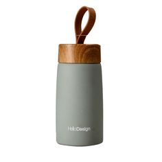 a wooden handle on the top of a gray and grey tumbler with wood lid