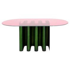 a pink and green table sitting on top of a white floor