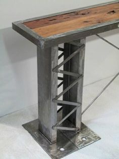 a table made out of metal and wood with a wooden top that has been turned into a shelf