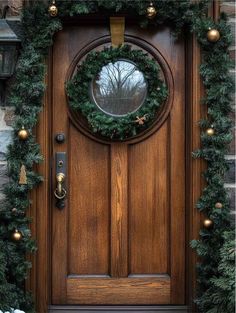 a wooden door decorated with christmas wreaths and lights