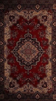 a red and black rug with an ornate design