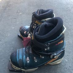 two pairs of snowboard boots sitting on the ground next to eachother's boot