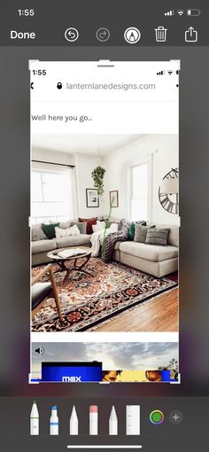 an image of a living room with couches and rugs on the floor in front of windows