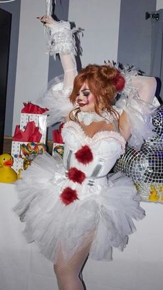 a woman dressed in white and red posing for the camera