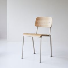 a wooden chair sitting on top of a white floor