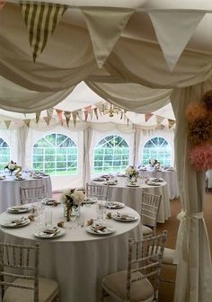 a banquet hall with tables and chairs covered in white linens