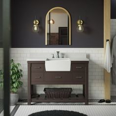 a white sink sitting under a bathroom mirror next to a wooden cabinet and counter top