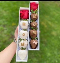 two boxes filled with chocolate covered strawberries and roses