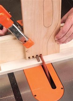 a person using a power tool on a piece of wood