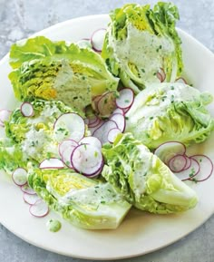 lettuce and radishes on a plate with dressing