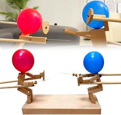 two different colored balls are on top of the same wooden stand and one is being pushed by an arrow