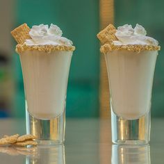 two glasses filled with whipped cream and cookies